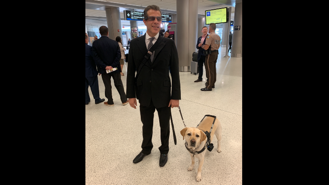 David New and his service dog Lola in the Miami International Airport